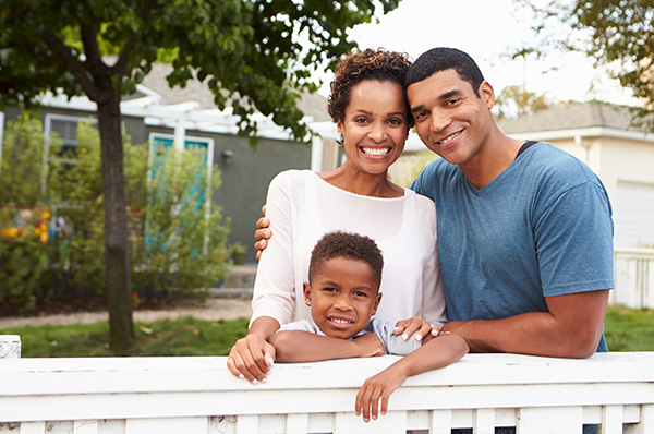 family in front of new home