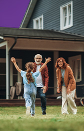 Grandparents with grandchild outside their house